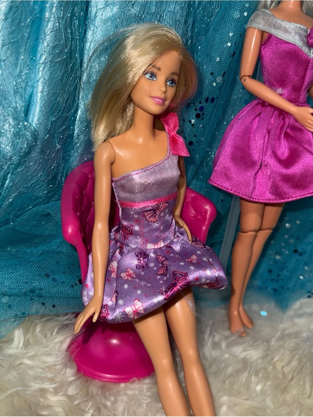 2 Barbie dolls in dresses 1 vintage 1 new chair not included